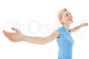 Blonde woman standing arms outstretched