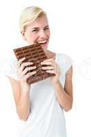 Attractive woman biting bar of chocolate