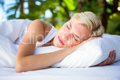 Beautiful blonde woman lying outside