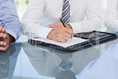 Businessman taking notes at conference