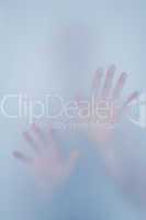 Hands touching frosted glass