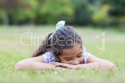 Little girl sleeping in a park