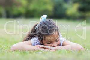 Little girl sleeping in a park