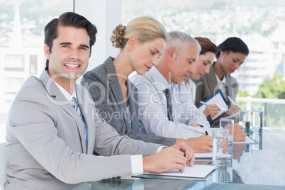 Business team taking notes during conference