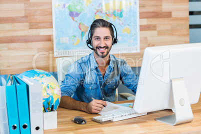 Smiling travel agent looking at camera