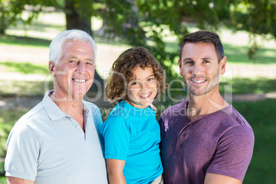 Extended family smiling in the park