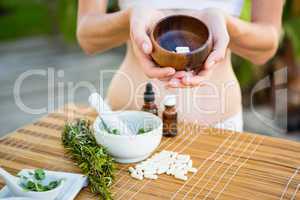 Fit woman showing bowl of pills