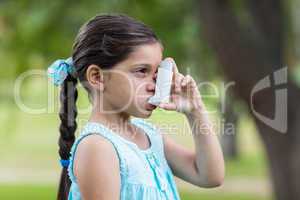 Little girl using his inhaler