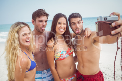 group of friends in swimsuits taking a selfie