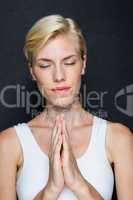 Attractive blonde woman praying