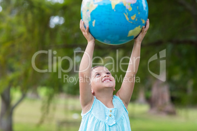 Little girl holding a globe