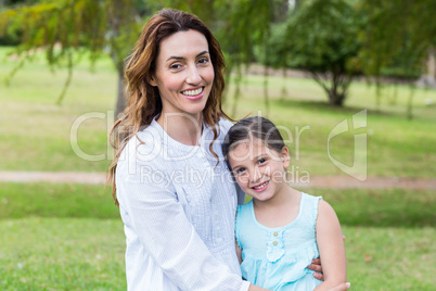 Happy mother and daughter smiling at the camera