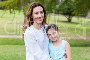 Happy mother and daughter smiling at the camera