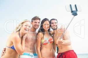 group of friends in swimsuits taking a selfie