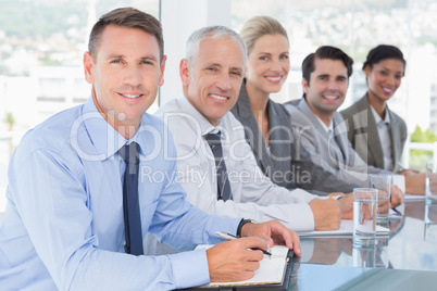 Business team smiling at camera during conference