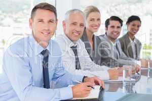 Business team smiling at camera during conference