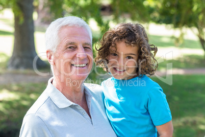 grandfather and grandson having fun in a park