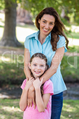 Happy mother and daughter smiling at the camera Happy mother and daughter smiling at the camera