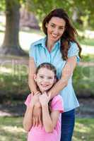 Happy mother and daughter smiling at the camera