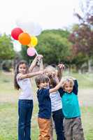 Happy children holding balloons