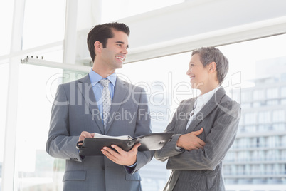 Business colleagues smiling at each other