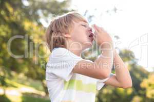 Little boy blowing his nose