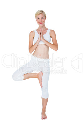 Fit woman doing tree pose