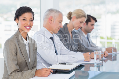 Business team taking notes during conference