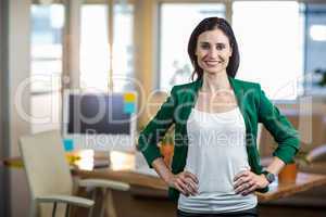 Smiling brunette standing hands on hips