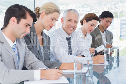 Business team taking notes during conference