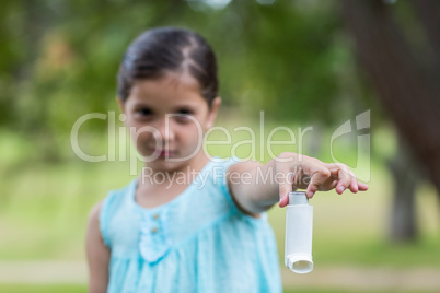 Little girl showing his inhaler