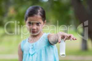 Little girl showing his inhaler