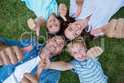 Happy family in the park together thumbs up