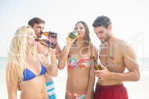 group of friends in swimsuits taking a selfie