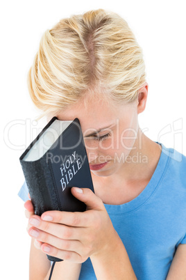 Pretty blonde woman holding bible