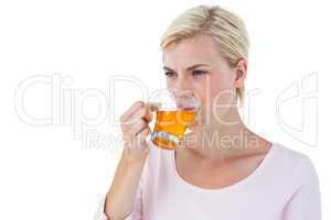 Attractive blonde woman drinking tea