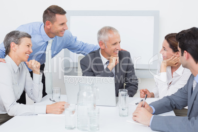 Business team working happily together on laptop