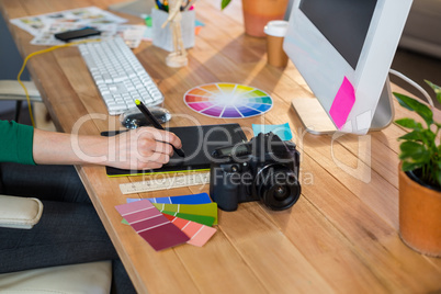 Designer working with colour wheel and digitizer