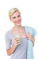 Fit woman holding healthy juice and towel