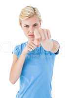 Stern blonde woman pointing with her finger