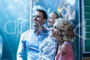 Happy family looking at fish tank