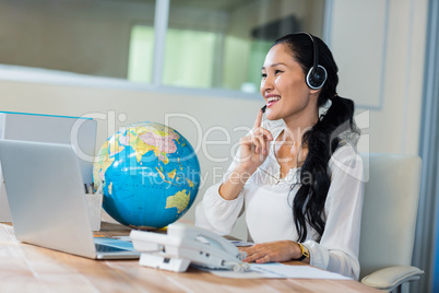 Pretty travel agent speaking to customer