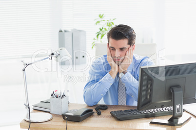 Sad businessman sitting at his desk