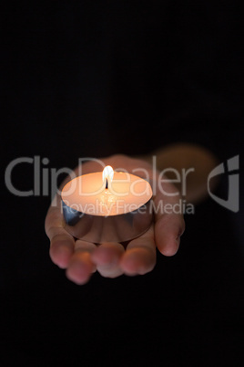 Hand holding candle