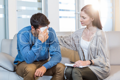 Psychologist comforting a depressed man