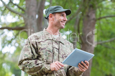 Soldier looking at tablet pc in park