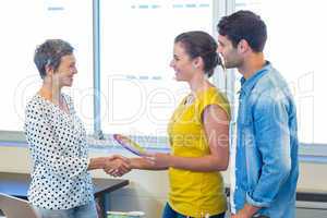 Casual businesswomen shaking hands