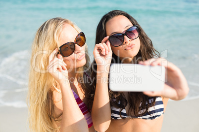 two friends in swimsuits taking a selfie