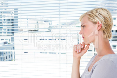 Thoughtful woman standing by the window
