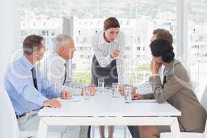 Irritated businesswoman talking to her colleague